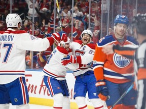 Oilers' Adam Larsson #6 reacts as Canadiens' Alexander Radulov, Alex Galchenyuk and Max Pacioretty, 67, celebrate a goal Sunday night in Edmonton.