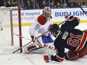 Canadiens' Carey Price  watches as Rick Nash of the New York Rangers falls on the rebound in the second period of an NHL hockey game at Madison Square Garden on Saturday, March 4, 2017, in New York.