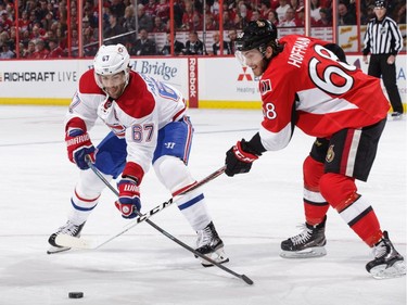 Mike Hoffman #68 of the Ottawa Senators battles for the loose puck against Max Pacioretty #67 of the Montreal Canadiens in the first period at Canadian Tire Centre on March 18, 2017 in Ottawa.