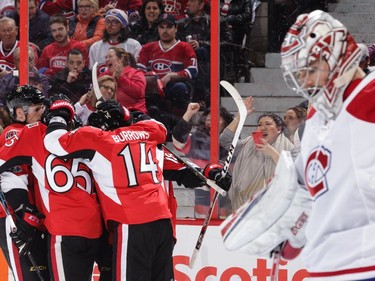 Erik Karlsson #65 of the Ottawa Senators celebrates his third period goal with team mates Alexandre Burrows #14and Dion Phaneuf #2 as Carey Price #31 of the Montreal Canadiens looks on at Canadian Tire Centre on March 18, 2017 in Ottawa.