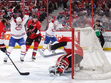 Brendan Gallagher #11 of the Montreal Canadiens celebrates his third period goal with team mate Tomas Plekanec #14 as Erik Karlsson #65, Dion Phaneuf #2 and Craig Anderson #41 of the Ottawa Senators defend the net at Canadian Tire Centre on March 18, 2017 in Ottawa.