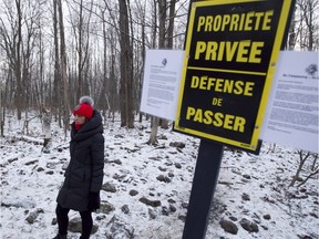 Rhonda Massad, a city councillor at the time, stands near a private property sign at Angell Woods in Beaconsfield on Dec. 10, 2011. The private owner of a portion of Angell Woods land is currently suing Beaconsfield for what he says is an abusive use of an interim bylaw which prevented him from developing his property. (Phil Carpenter/ THE GAZETTE)