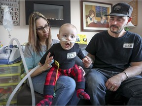 Marylène Fortin and T.R. Pursch with their son Jaxon at their home in Ste-Eustache, north of Montreal Monday February 27, 2017.  Jaxon has a condition that causes severe breathing pauses.  An  operation at Hospital Ste-Justine failed to help him so his parents have turned to crowdfunding to pay for a visit to a Boston specialist for consultation.