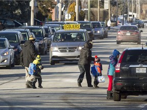 Parents and students cross Shamrock Street as they leave  St. Patrick Elementary school in Pincourt on  Jan. 13, 2017. 
 (Phil Carpenter / MONTREAL GAZETTE)