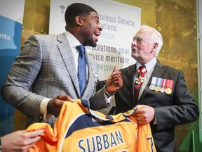 Nashville Predators' P.K. Subban laughs with Governor General David Johnston while giving him an autographed jersey after Johnston awarded Subban the Meritorious Service Decoration at the Montreal Children's Hospital in Montreal, Wednesday, March 1, 2017.