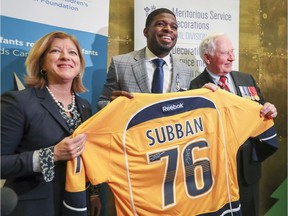 Nashville Predators' P.K. Subban smiles after presenting Governor General David Johnston with an autographed jersey after receiving the Meritorious Service Decoration from Johnston in a ceremony at the Montreal Children's Hospital in Montreal, Wednesday, March 1, 2017.  At left is Montreal Children's Hospital Foundation president Marie-Josée Gariépy.