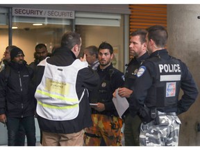 Police and Concordia University security personnel coordinate the evacuation of the school's EV Building in Montreal following a bomb threat targeting Muslim students on Wednesday March 1, 2017.