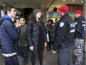 Police supervise the evacuation of Concordia University's EV Building n Montreal following a bomb threat targeting Muslim students Wednesday, March 1, 2017.