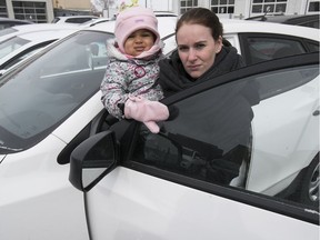 Allison Vickery and her daughter Juliet Lauture with their 2015 Hyundai Tucson on Saturday. Twice in the last month someone has stolen its catalytic converter after she parked the car at the Sunnybrooke train station.