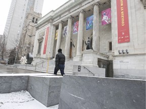 A Montrealer walks past outdoor furniture in front of the Montreal Museum of Fine Arts on Tuesday March 14, 2017. The city has awarded a contract for more than $300,000 for new plants and street furniture for the city's 375th anniversary.