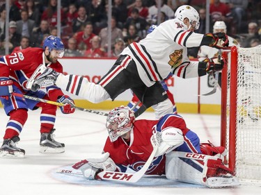 Chicago Blackhawks Richard Panik steps over Montreal Canadiens Carey Price after Price stopped his shot during second period of National Hockey League game in Montreal Tuesday March 14, 2017.