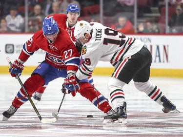Montreal Canadiens Alex Galchenyuk battles for the puck with Chicago Blackhawks Jonathan Toews during first period of National Hockey League game in Montreal Tuesday March 14, 2017.