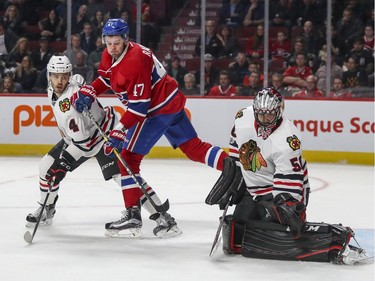 Montreal Canadiens Alex Radulov watches teammate Shea Weber's shot beat Chicago Blackhawks Corey Crawford during third period of National Hockey League game in Montreal Tuesday March 14, 2017. Hawks Niklas Mjalmarsson watches at left.