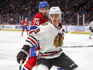 Canadiens' Alexei Emelin trails Blackhawks' Jonathan Toews during second period Tuesday night at the Bell Centre.