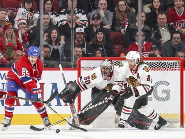 Montreal Canadiens Andrew Shaw, left, tries to deflect shot in front of Chicago Blackhawks goalie Corey Crawford and defenceman Duncan Keith during second period of National Hockey League game in Montreal Tuesday March 14, 2017.