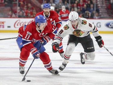 Montreal Canadiens Brendan Gallagher looks to make a pass against Chicago Blackhawks Nick Schmaltz while defenceman Shea Weber trails the play during first period of National Hockey League game in Montreal Tuesday March 14, 2017.