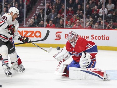 Montreal Canadiens Carey Price makes a save on a shot by Chicago Blackhawks Marian Hossa, left, during second period of National Hockey League game in Montreal Tuesday March 14, 2017.