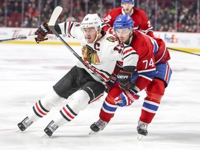 Canadiens defenceman Alexei Emelin checks Blackhawks Jonathan Toews during second period Tuesday night at the Bell Centre. Emelin had a rough game, going minus -3 for the night.