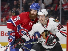 Montreal Canadiens defenceman Jordie Benn leans on  Chicago Blackhawks Ryan Hartman during second period of National Hockey League game in Montreal Tuesday March 14, 2017.