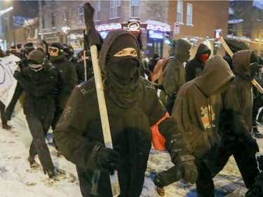 Anti-police brutality demonstrators march west on Ontario St. in Hochelaga-Maisonneuve to downtown Montreal Wednesday March 15, 2017.