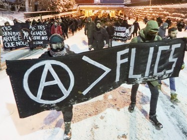 Anti-police brutality demonstrators march west on Ontario St. in Hochelaga-Maisonneuve to downtown Montreal Wednesday March 15, 2017.