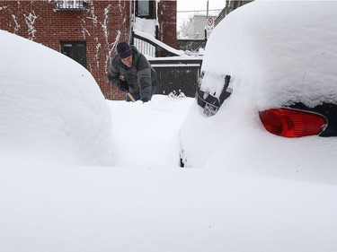 Christian Hamel has a long way to go before getting to his car, as he shovels on Chambord St. in the Plateau on Wednesday March 15, 2017 following the massive snowfall overnight. (Pierre Obendrauf / MONTREAL GAZETTE)