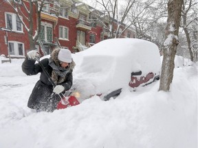 Marie Gareau shovels out her card on Walker St. in Montreal Wednesday March 15, 2017.