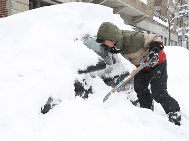 I hope it's mine! Michel Larouche makes sure he's shovelling out his own car on De la Roche St. in the Plateau on Wednesday, March 15, 2017, in anticipation of the massive snow-clearing operations following the overnight snowstorm.