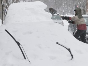 Michel Larouche shovels snow from his car before the city starts clearing on de la Roche St. in the Plateau on Wednesday March 15, 2017.