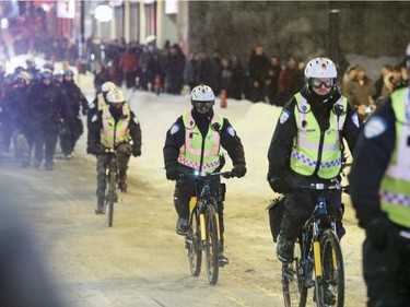 Police on bicycles chase anti-police brutality demonstrators on Ste-Catherine St. in downtown Montreal Wednesday March 15, 2017.