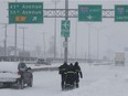 Workers make their way back from Highway 13 after spending the night stranded in their truck on Wednesday March 15, 2017. A major section was shutdown by stalled vehicles because of the heavy snowfall that occurred overnight.