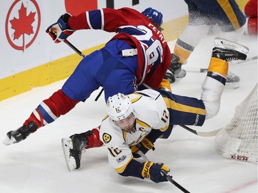 Nashville Predators' Mike Fisher (12) and Montreal Canadiens' Jeff Petry (26) fall to the ice after colliding next to goalie Carey Price (31) during second period NHL action in Montreal on Thursday March 2, 2017.