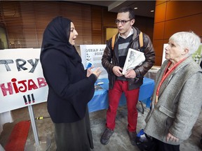 Razia Hamidi, left, has a conversation with Beverly Bernardo and Philippe Tessier on the last day of Concordia's Muslim Students' Association's Islamic Awareness Week at the school's EV Building in Montreal, Thursday March 2, 2017, despite the bomb threat that targeted Muslim students at the university on Wednesday.