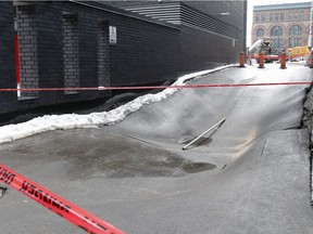 Safety tape surrounds a laneway that collapsed behind the Roccabella development project between Drummond and Mountains Sts. in Montreal Tuesday March 21, 2017.