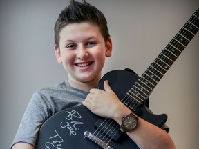 Eleven-year-old Nathan Guilbault holds the autographed guitar he got from Green Day after being invited up on stage to play with them during their Bell Centre concert Wednesday night. Nathan was photographed at his home in Beaconsfield, west of Montreal Thursday March 23, 2017.