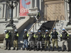 Police protect Montreal city hall during a protest and counter-protest by members of the far-right and anti-racist protesters in front of city hall Saturday, March 4, 2017.