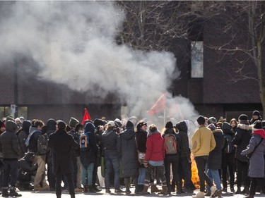 Protester burn their signs and flags in Place Émilie-Gamelin after a protest against racism and Islamaphobia in front of Montreal city hall Saturday, March 4, 2017.