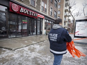 A Montreal Police arson investigator at the Boustan restaurant at Sherbrooke St. and Grand Blvd in Montreal on Tuesday March 7, 2017.