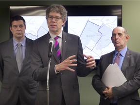 Côte-des-Neiges-NDG mayor Russell Copeman, centre, speaks during a meeting with Town of Mount Royal mayor Philippe Roy, left, and Montreal City Council member Marvin Rotrand where the announced a coalition to fight the redrawing of the provincial electoral map in Montreal