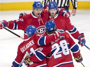 Canadiens winger Brendan Gallagher celebrates with teammates Tomas Plekanec, left, Paul Byron, top right, and Nathan Beaulieu after Byron's first goal Thursday night at the Bell Centre.
