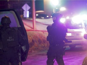 Police survey the scene of a shooting at a Quebec City mosque on Sunday January 29, 2017.