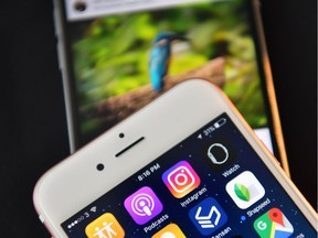 LONDON, ENGLAND - AUGUST 03:  The Instagram app logo is displayed next to an "Instagrammed" image on another iPhone on August 3, 2016 in London, England.