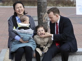 Robert Kelly, right, a political science professor at Pusan National University, waits for a press conference with his wife Jung-a Kim, left, and children James and Marion, at the university in Busan, South Korea, Wednesday, March 15, 2017. As Kelly speaks from his home office via Skype with BBC about the just-ousted South Korean president, his eyes dart left as he watches on his computer screen as his young daughter parades into the room behind him.