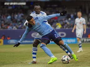 Montreal Impact's Dominic Oduro, top, vies for the ball with New York City FC's Ronald Matarrita, front, during an MLS Eastern Conference soccer match at Yankee Stadium in New York, Saturday, March 18, 2017.