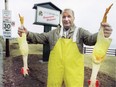 Then Dorval mayor Peter Yeomans holds up some rubber chickens as part of his annual pothole challenge in 1996.