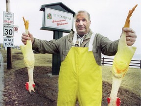 Then Dorval mayor Peter Yeomans holds up some rubber chickens as part of his annual pothole challenge in 1996.