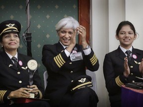 The commander of an all- women Air India Delhi-San Francisco Delhi flight, Kshamta Bajpai, centre, with other pilots, cheers her crew during the celebration ceremony at a function on the eve of International Women's Day, in New Delhi, India, Tuesday, March 7, 2017. Air India says it has set a world record by flying around the world with an all-female crew. Press Trust of India reported that the flight flew over the Pacific Ocean from New Delhi to San Francisco on Monday, and then flew back to New Delhi over the Atlantic on Friday.