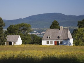 The house which sits in a field of yellow blooms, takes in the view of Mont Ste-Anne.