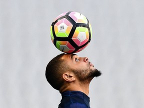 Photo of the day: France's defender Layvin Kurzawa does a little balancing act during a training session at the Stade de France near Paris, on March 27, 2017, on the eve of the of their friendly football match against Spain.