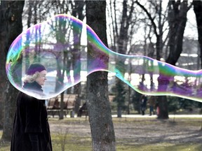 Photo of the day: A woman walks next to a soap bubble made by a street artist in the Ukrainian capital, Kiev, on a sunny day, March 15, 2017.